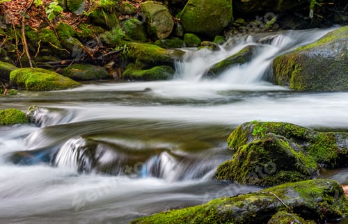 Preview: Small Cascades On The Forest River Among Huge Boulders Covered With Moss. Taken With Long Exposure