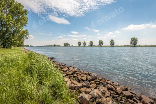 Preview: Stones On The Banks Of A Dutch River Provide Protection Against Erosion. The Photo Was Taken In The
