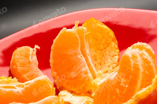 Preview: Tangerines, Peeled Tangerine And Tangerine Slices In A Red Plate On Black Background