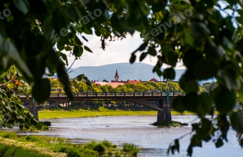 Preview: Longest Linden Alley In Europe. Summer Landscape Behind The Branches On The River Embankment In