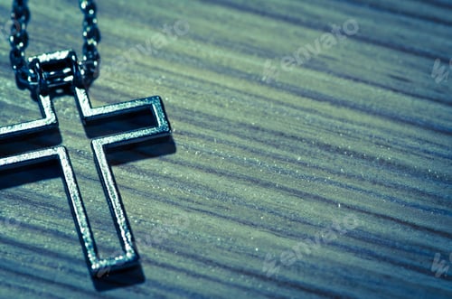 Preview: Detail Of Silver Cross Over Wooden Background