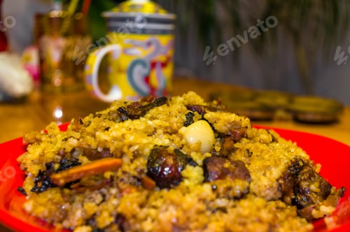 Preview: Uzbek Pilaf With Meat In A Red Plate On A Wooden Table, Close Up
