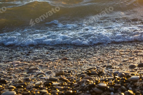 Preview: Sea Pebble Beach With Multicoloured Stones, Transparent Waves With Foam, On A Warm Evening