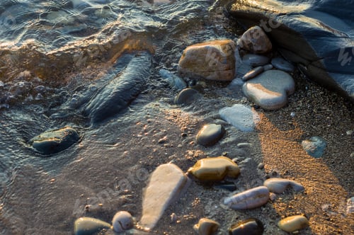 Preview: Pebble Stones On The Sea Beach On A Warm Summer Day, The Rolling Waves Of The Blue Sea With White