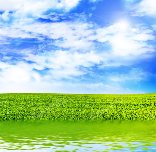 Preview: Meadow With Green Grass On A Background Of Blue Sky With Clouds