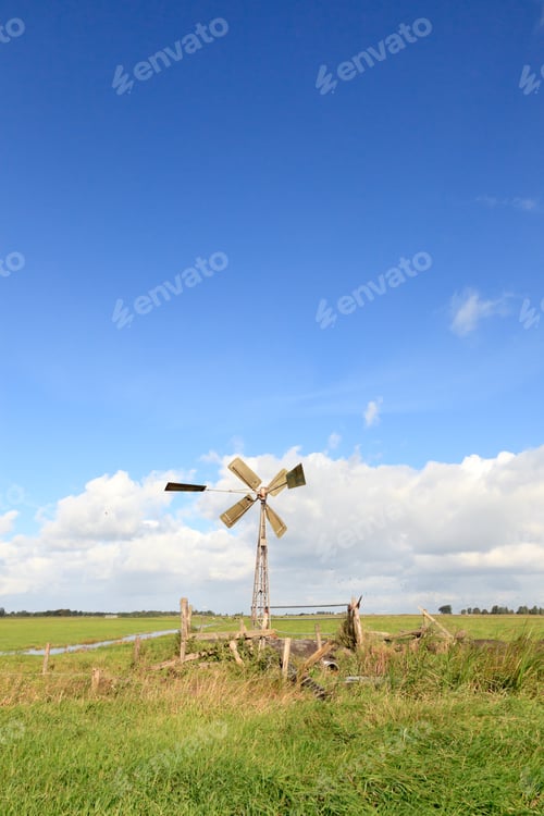 Preview: Dutch Farmland With Windmill Under Blue Cloudy Sky