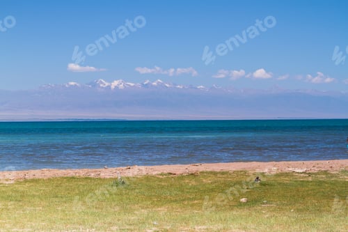 Preview: Beach At Lake Issyk Kul, Kyrgyzstan, Central Asia. Tian Shan Mountains In The Background.