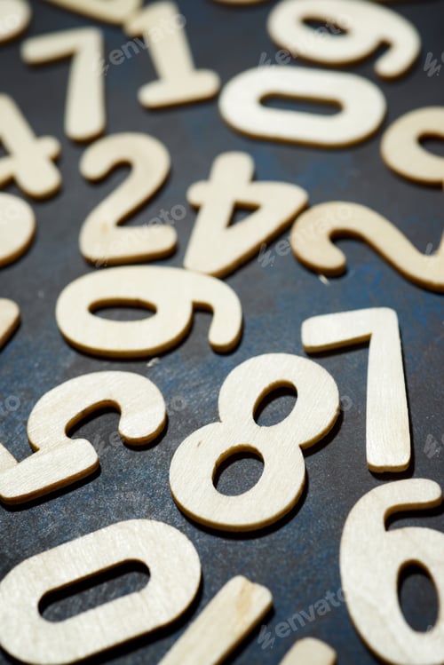 Preview: Wood Numbers On A Table.