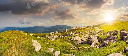 Preview: Mountain Panorama Landscape. Valley With Stones In Grass On Top Of The Hillside Of Mountain Range