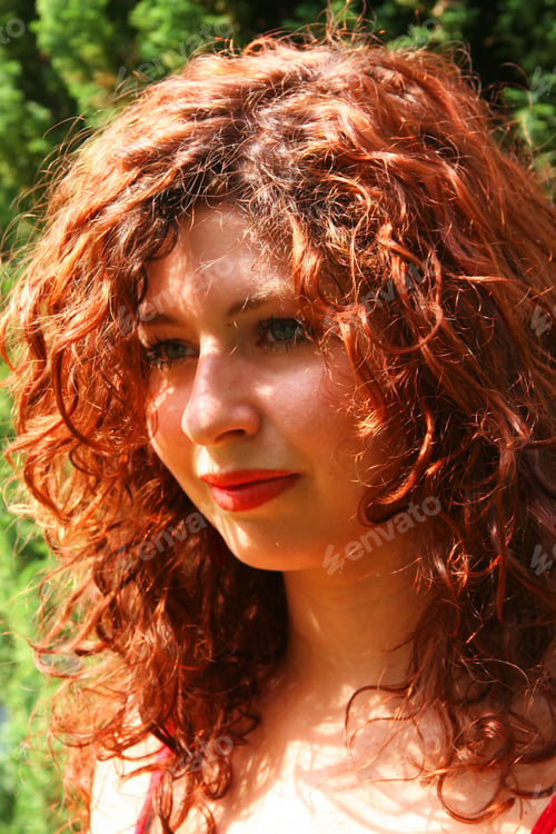 Preview: Beautiful Young Female Model With Long Red Curly Hair Posing In Closeup For The Camera