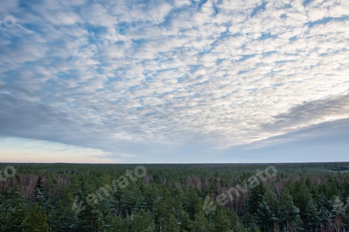 Preview: Dark Storm Clouds Over Meadow With Green Grass And Mountains In Background