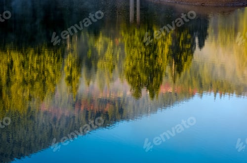 Preview: Beautiful Abstract Nature Background Of Lake Surface Reflecting Spruce Forest On Hillside Textures