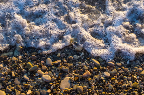 Preview: Sea Pebble Beach With Multicoloured Stones, Transparent Waves With Foam, On A Warm Evening