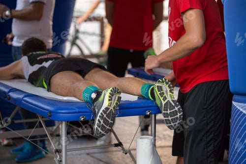Preview: Athlete on Massage Table Receiving Treatment After Race