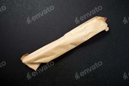 Preview: Paper Bag On A Black Table.