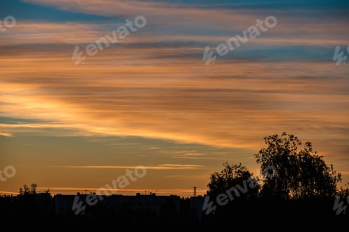 Preview: Abstract Colored Sunset Sky With Broken Clouds Over City Silhouettes
