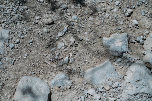 Preview: Stony Desert Soil Texture. Gray Dry Ground With Small Stones. Close-Up From Above