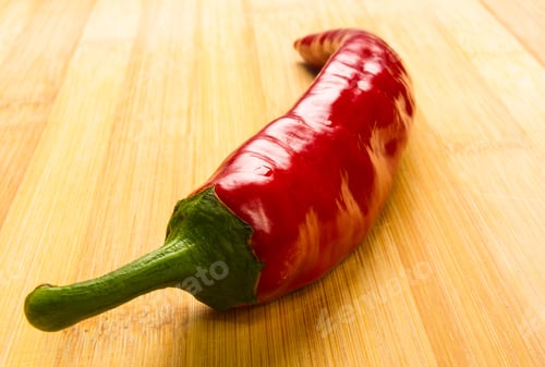 Preview: Red Chili Pepper On A Wooden Background
