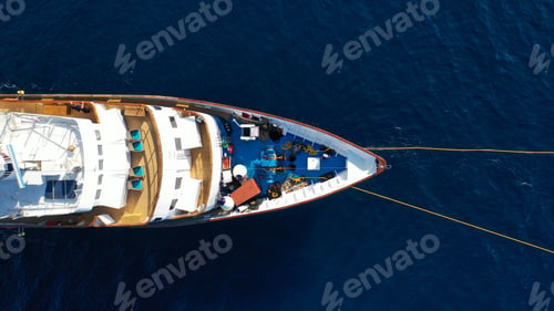 Preview: Aerial Drone Photo Of Luxury Yacht Docked In Deep Blue Sea Near Old Port Of Fira Of Santorini