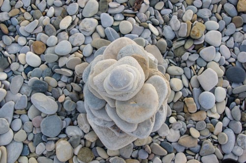 Preview: Folded Pyramid Zen Pebble Stones On The Sea Beach At Sunset