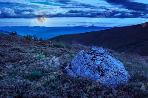 Preview: Mountain Panorama With Large Rock In Grass On The Hillside At Night