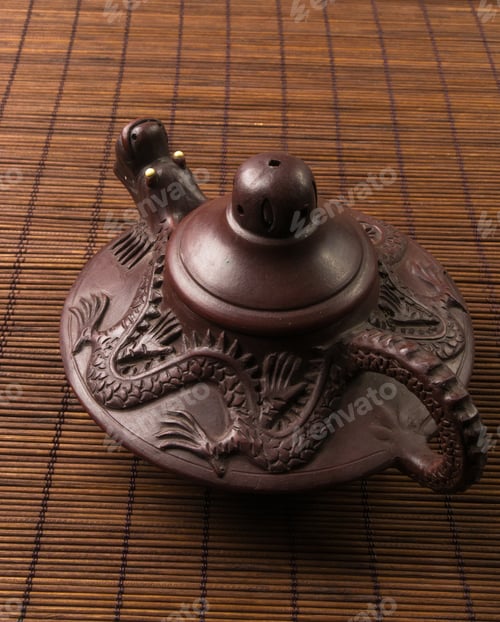 Preview: Brown Chinese Teapot Of Yixing Clay With Traditional Ornament On Bamboo Mat