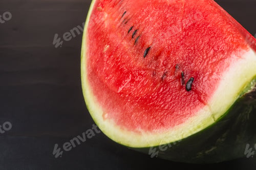 Preview: A Quarter Of A Ripe Watermelon On A Black Background