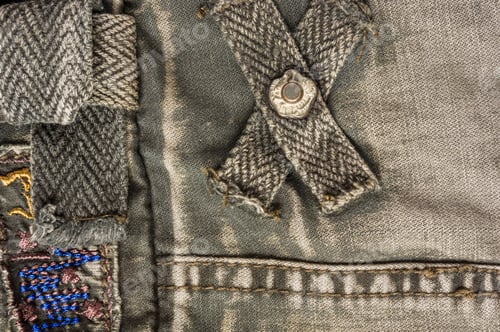 Preview: Clothing Items Stonewashed Cotton Fabric Texture With Seams, Clasps, Buttons And Rivets, Macro
