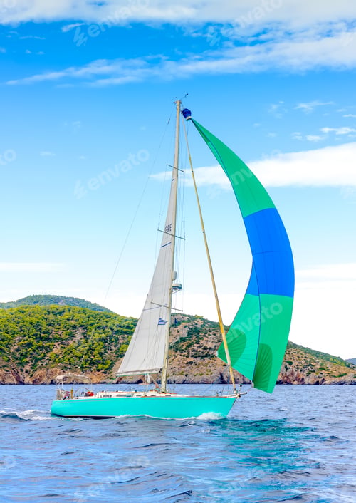 Preview: Sailing Boat With A Green - Blue Spinnaker During A Regatta Out Of Poros Island In Greece