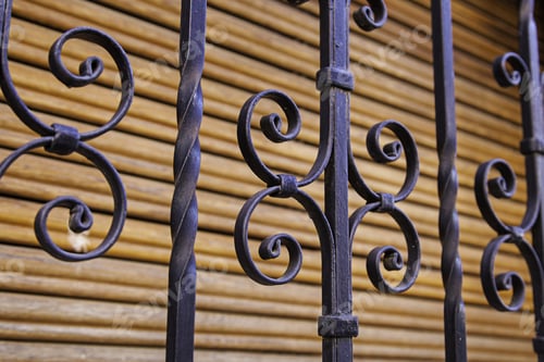 Preview: Ironwork Design Against Wooden Louvered Background