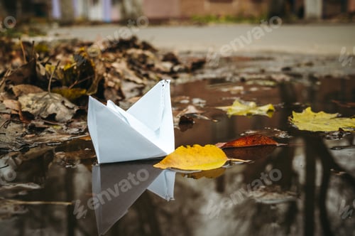 Preview: White Paper Boat And Autumn Puddle On The City Street