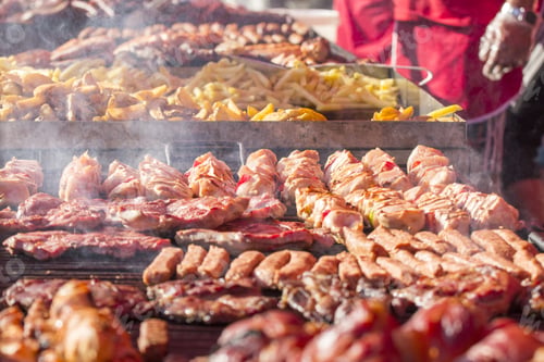 Preview: Different Kind On Grilled Meat, Sausages And Fried Potatoes With Smoke And Steam From De Grill