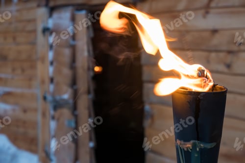 Preview: Fire Burning Inside Metal Torch In Front Of A Wooden Shed In A Sami People Village, Northern Norway