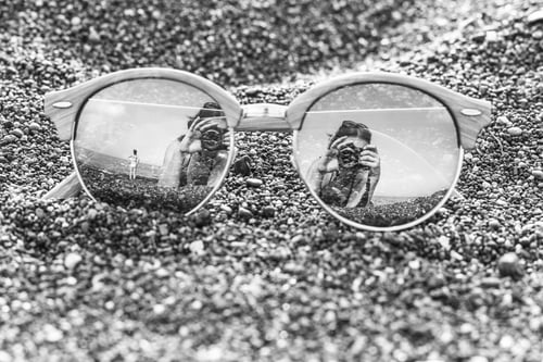 Preview: Close Up Of Sun Glasses On Black Stony Background Reflecting Photographer