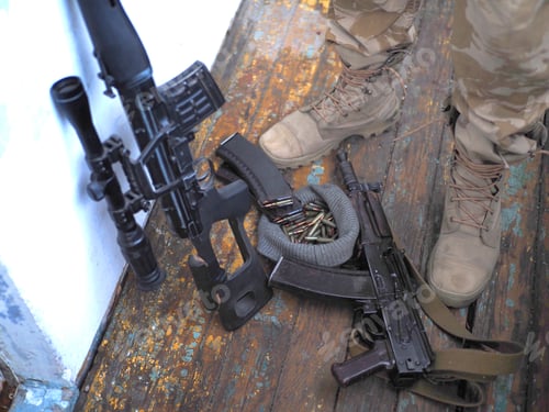 Preview: Soldier Boots, Sniper Rifle And Handgun Close Up. War Conflict.