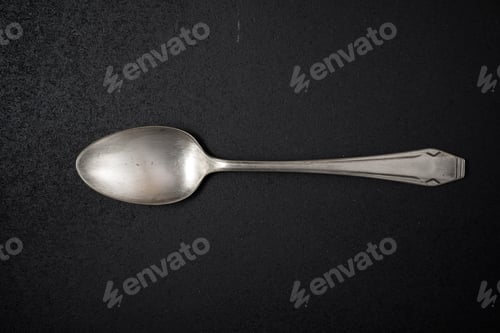 Preview: Metal Spoon On A Black Table.