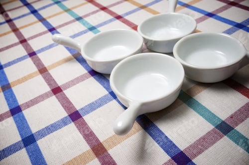 Preview: Small White Spoons On A White Tablecloth