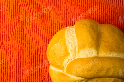 Preview: Fresh Braided Loaf Of White Wheat Bread On An Orange Napkin