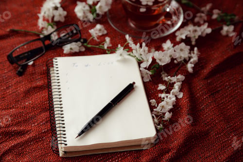 Spring Flat Lay Top View Home Office Workspace - Notebook With Tea Cup And Cherry Blossom Branches