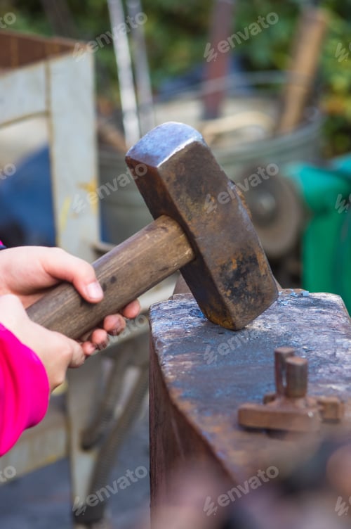 Preview: Blacksmith And Apprentice Working On The Anvil, Close-Up