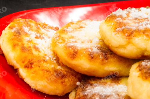 Preview: Red Plate Of Pancakes In Powdered Sugar On Black Background