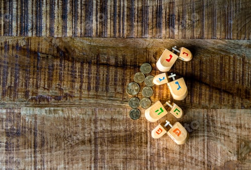 Preview: Traditional Wooden Dreidels And Coins For Hanukkah Celebration.