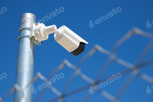 Preview: Closeup Of A Surveillance Camera And Clear Sky.