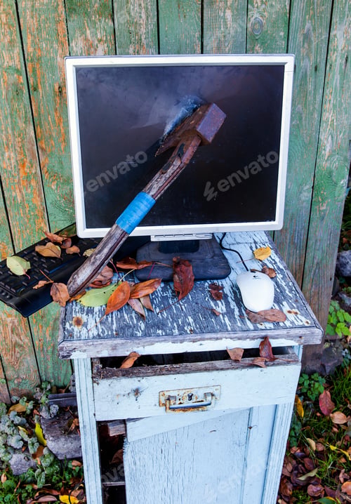 Preview: Axe In A Computer Screen Monitor On The Old Planks Background Outdoor