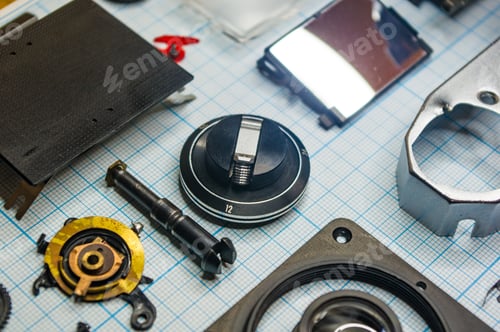 Preview: Parts Are Completely Disassembled Old Retro Film Slr Camera On Graph Paper, Close-Up