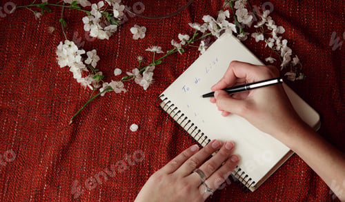 Preview: Woman'S Hands Holding Pen And Spiral Notepad As Mockup For Your Design. Red Background, Flat Lay