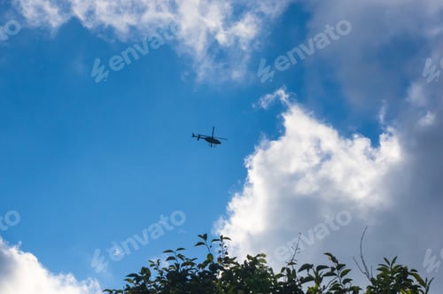 Preview: Flying A Helicopter In The Blue Sky With White Clouds Summer Day