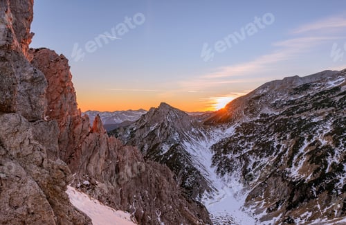 Preview: Male Hiker At The Top Of The Mountain At Sunset