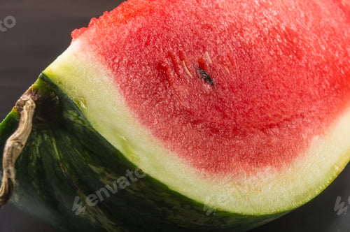 Preview: A Quarter Of A Ripe Watermelon On A Black Background