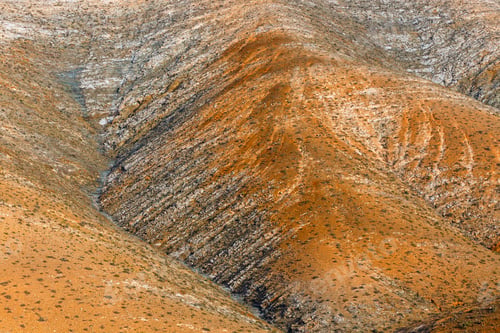 Preview: The View Of The Hills At Sunset On Fuerteventura Island. The Dominant Colour Is Red And Orange